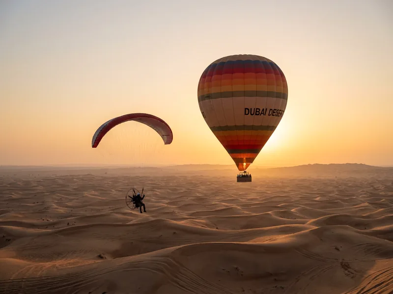 Paramotor banner moment above the desert