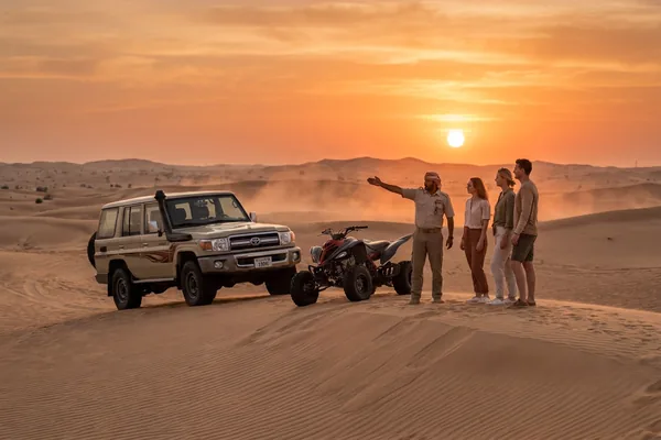 Safari and ATV combo energy across the dunes