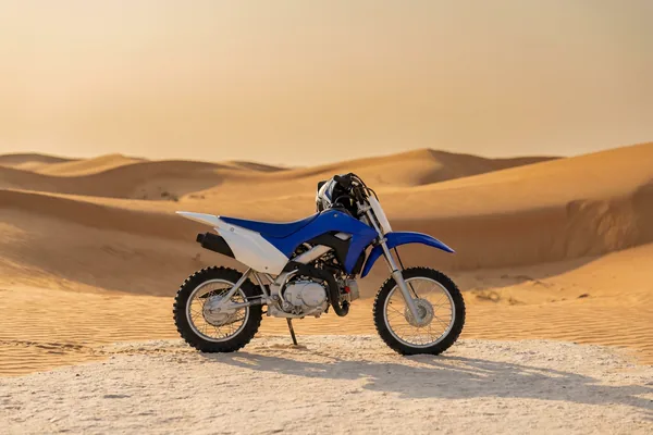 KTM dirt bike riding a warm Dubai dune