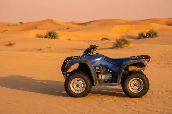 Entry quad bike crossing open desert sand