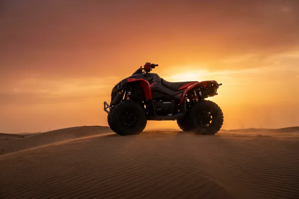 Flagship quad bike blasting through Dubai dunes at sunset